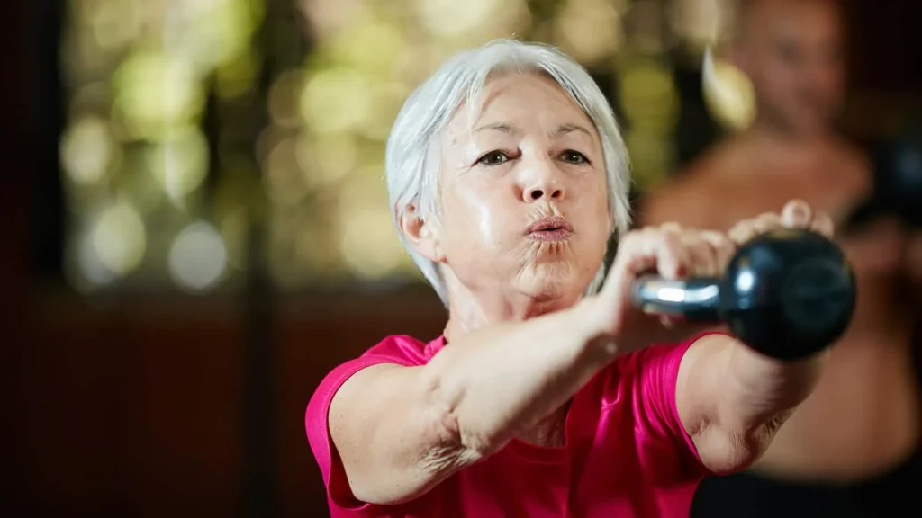 Toning Arms Without the Bulk: Is It Achievable? 1 Woman doing resistance band exercises for toned arms Billingshurst